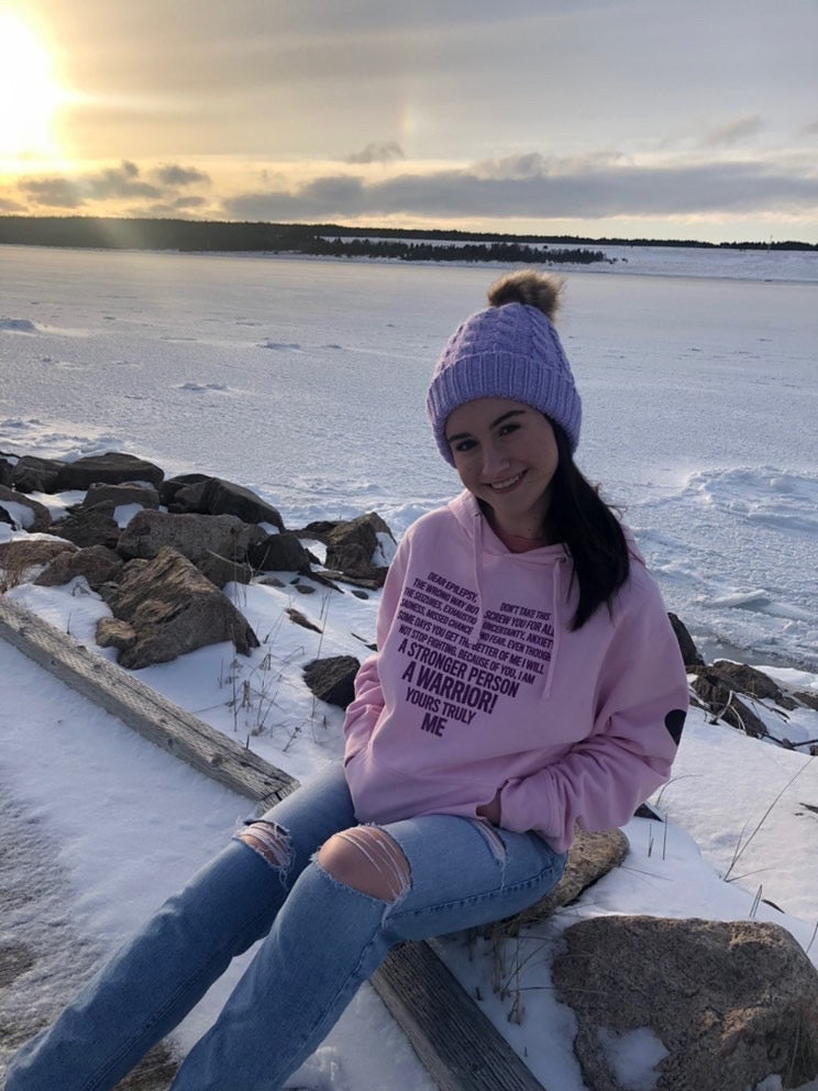 A community member wearing a hoodie outdoors