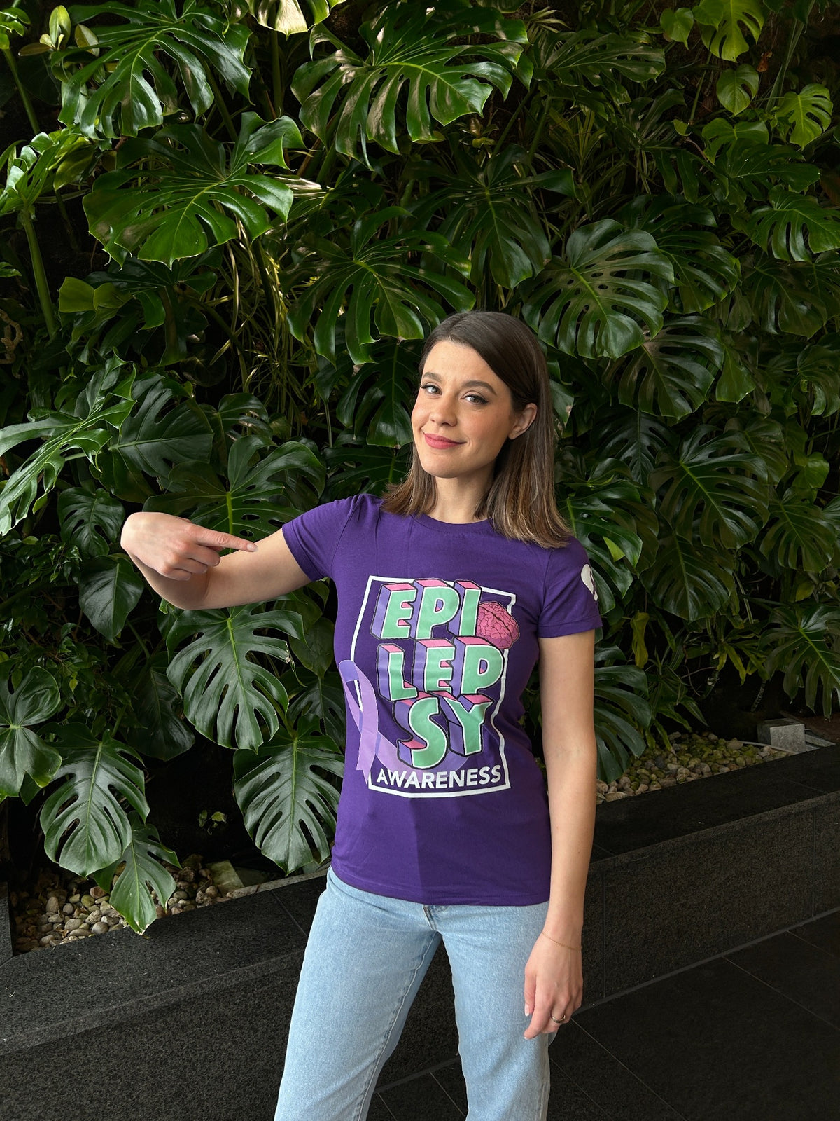 A community member wearing a purple shirt outdoors