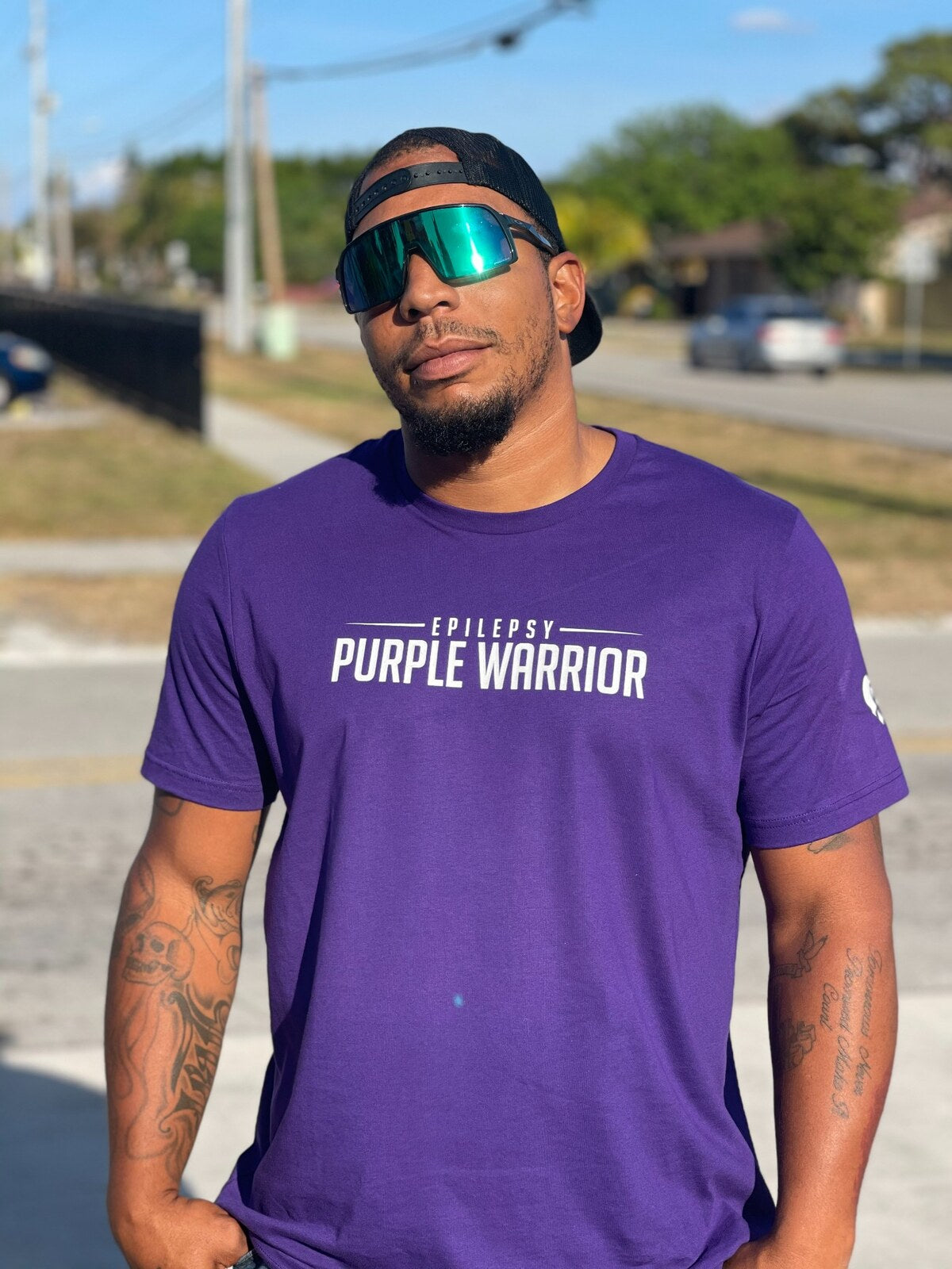 A community member wearing a purple T-shirt